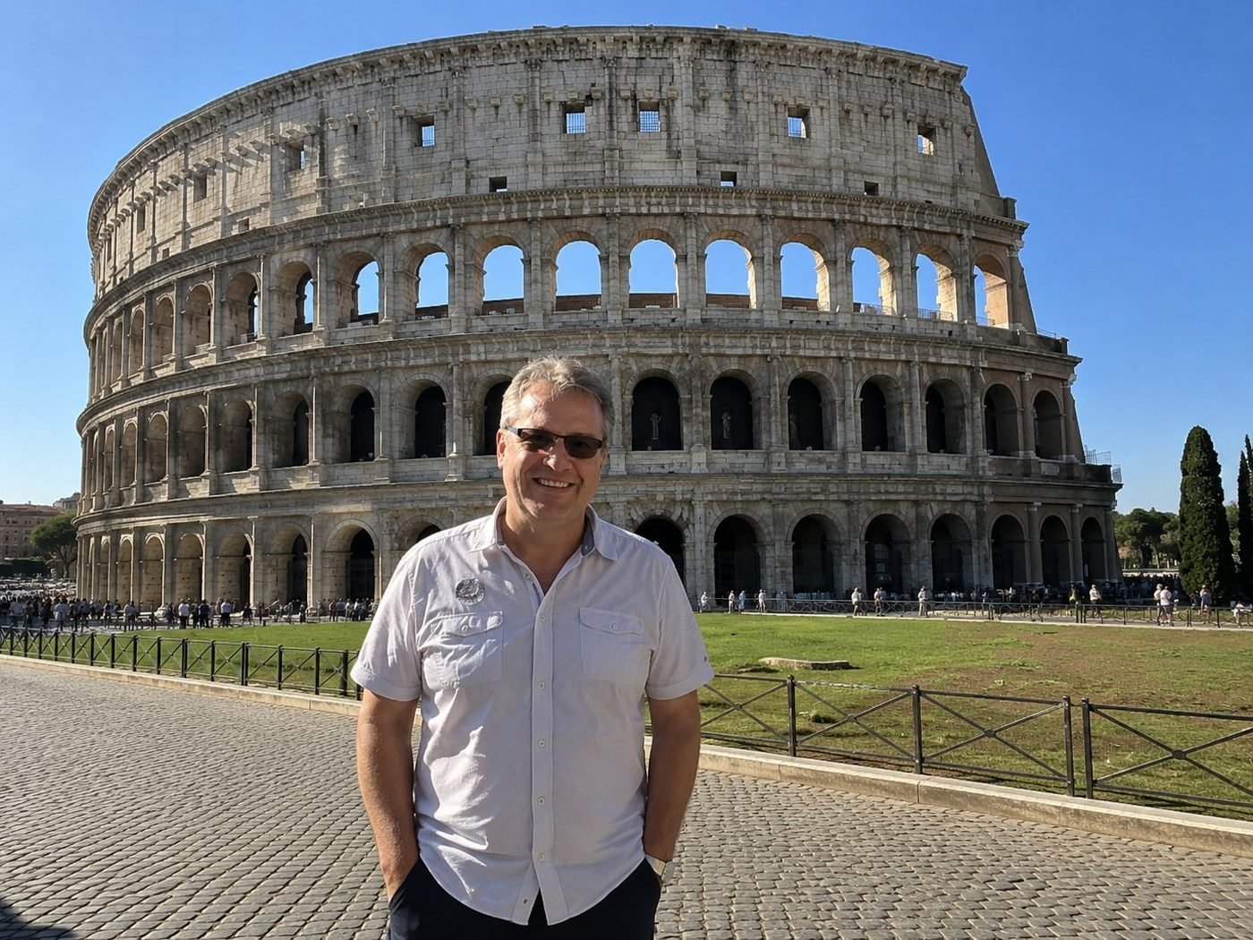 Radim Kaufmann at the Colosseum in Rome, with the ancient Flavian Amphitheatre's tiered arches in full sunlight behind him